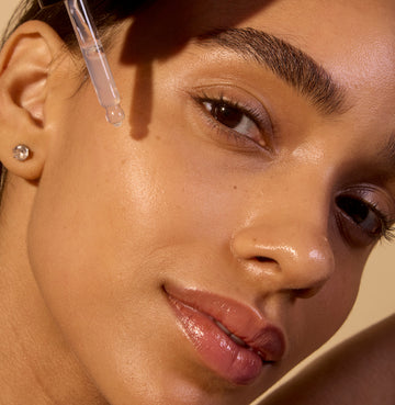 Woman applying serum for a radiant look